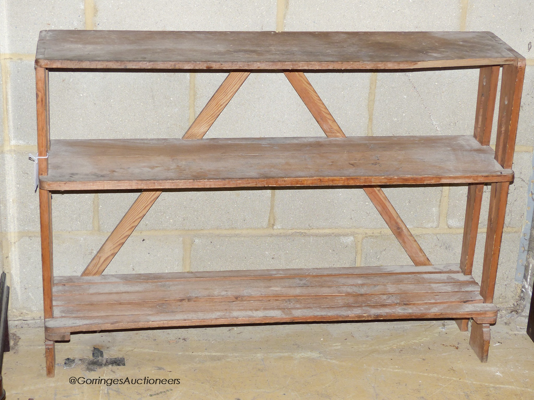 An Art nouveau pine three tier shelf or boot rack. W-108, D-28, H-78cm.